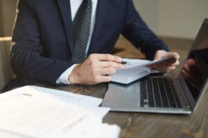 Lawyer looking at document over laptop