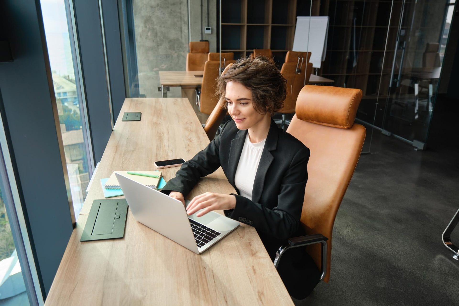 A woman sitting while using her laptop