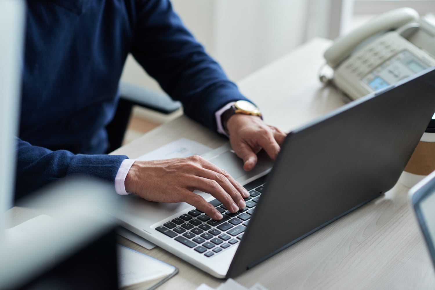 man in a suit working on a laptop