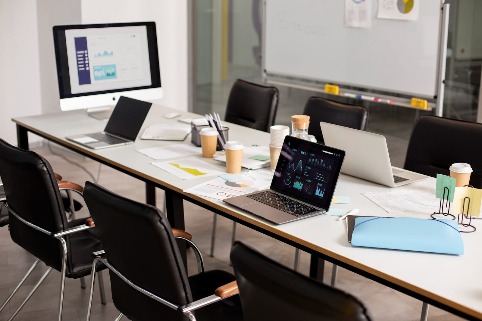 an office table with laptops