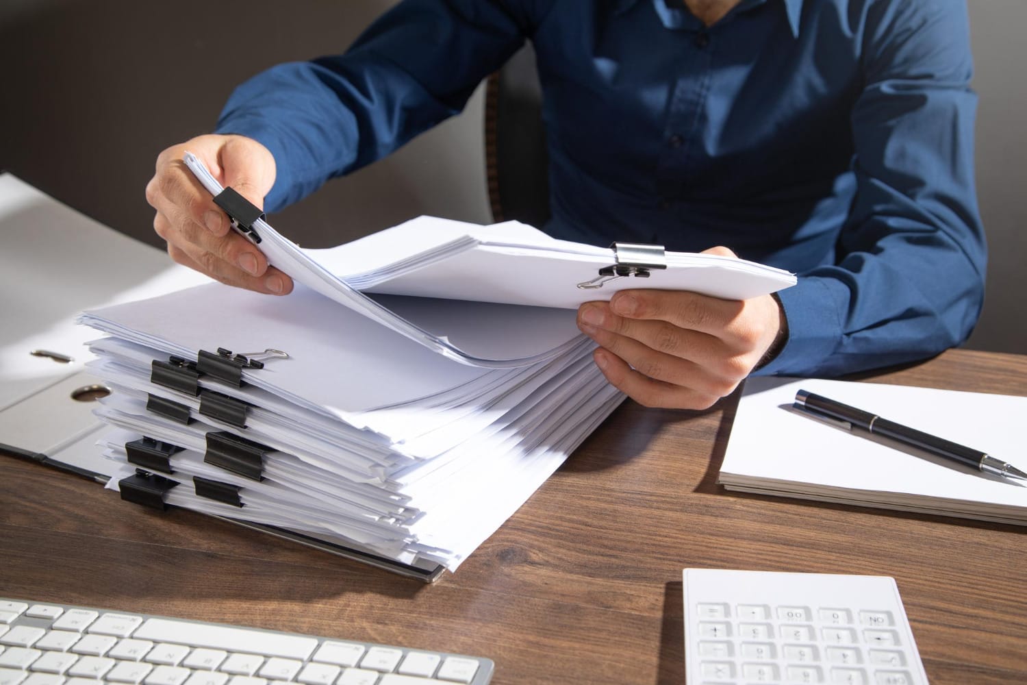 man going through a pile of documents