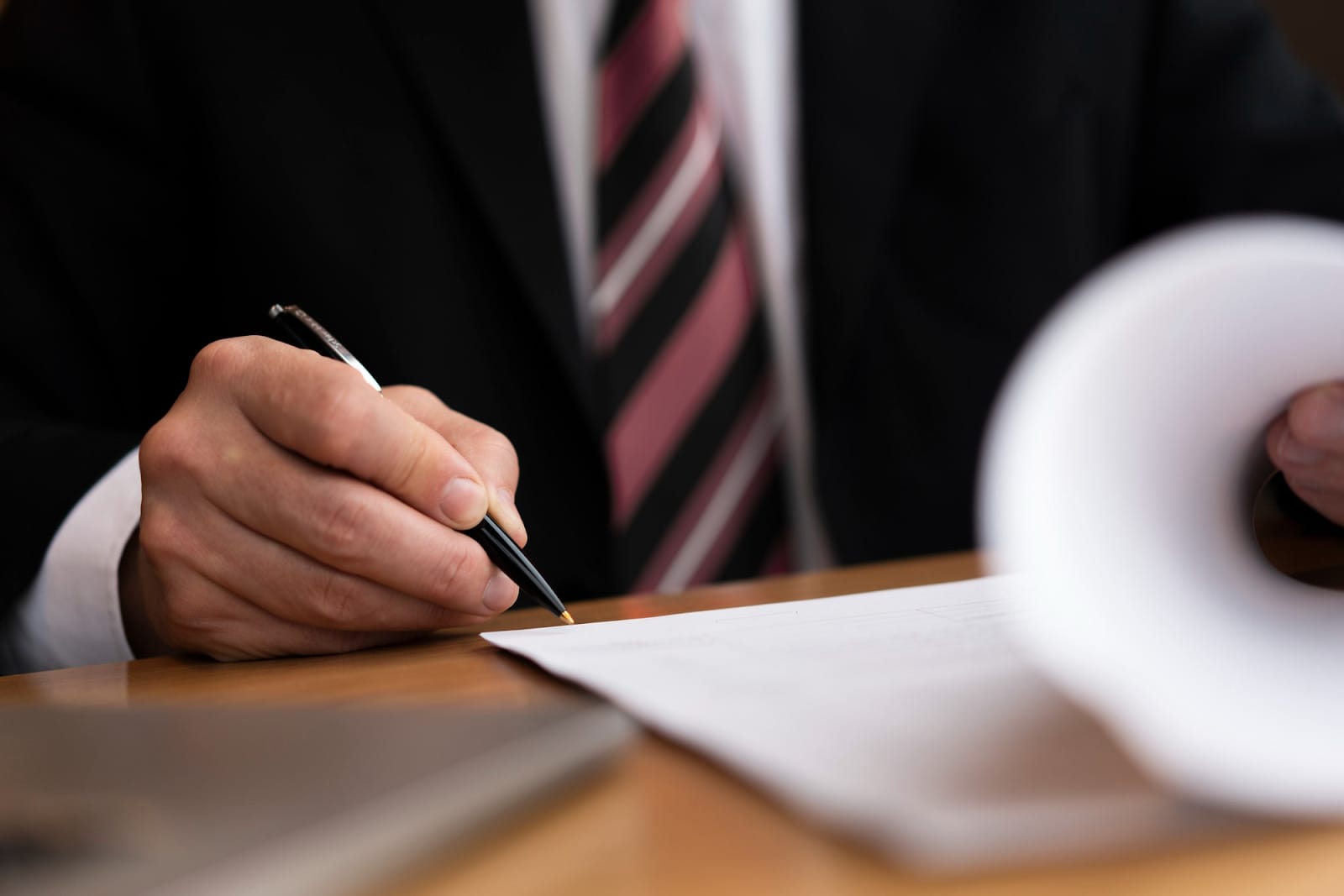 businessman signing contracts with a pen