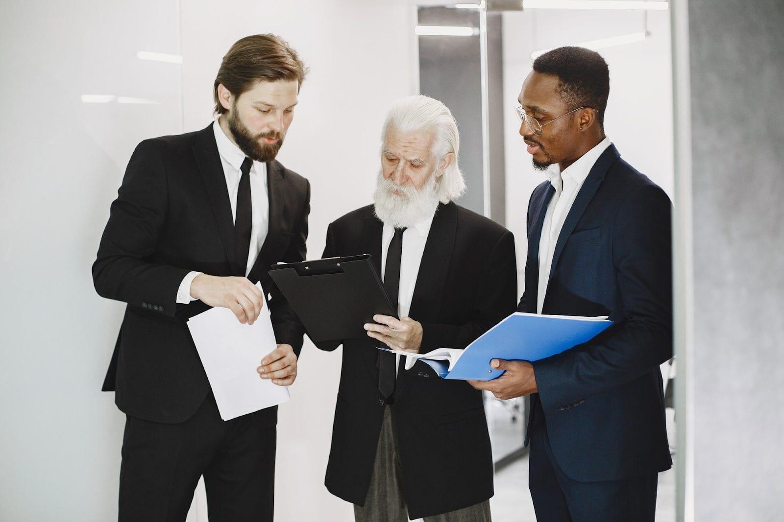 Three lawyers discussing paperwork