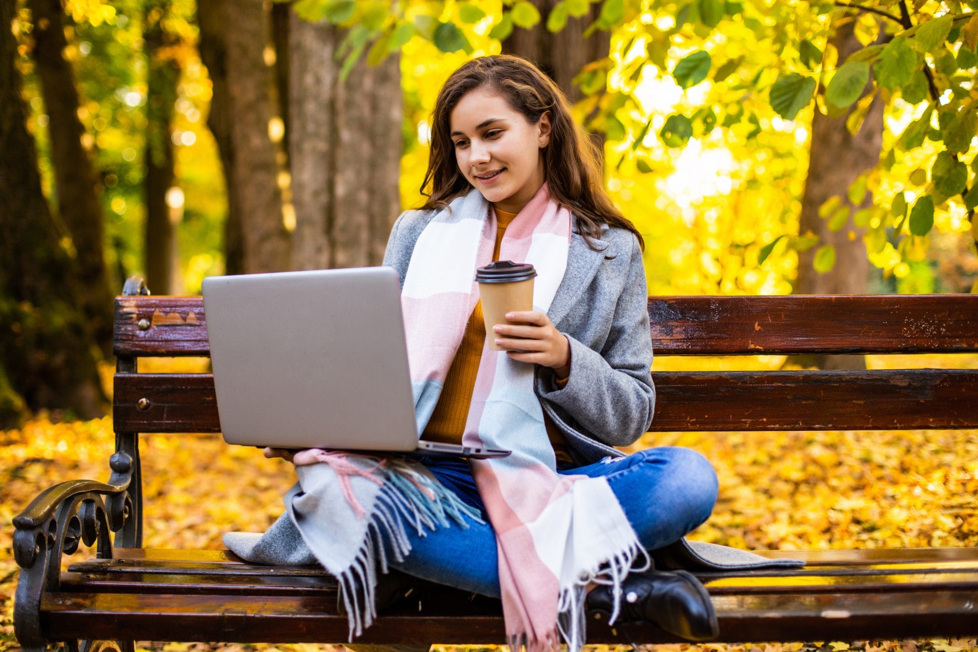 Woman working on her laptop in a park