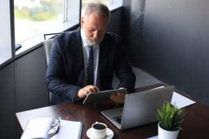 Lawyer using a tablet and laptopt