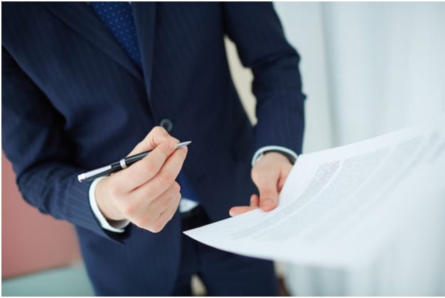 business man holding a pen and paper