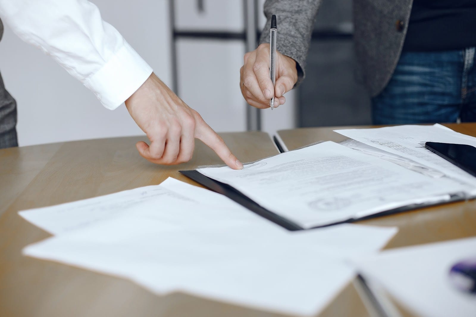 Lawyer showing the dotted line for the client to sign