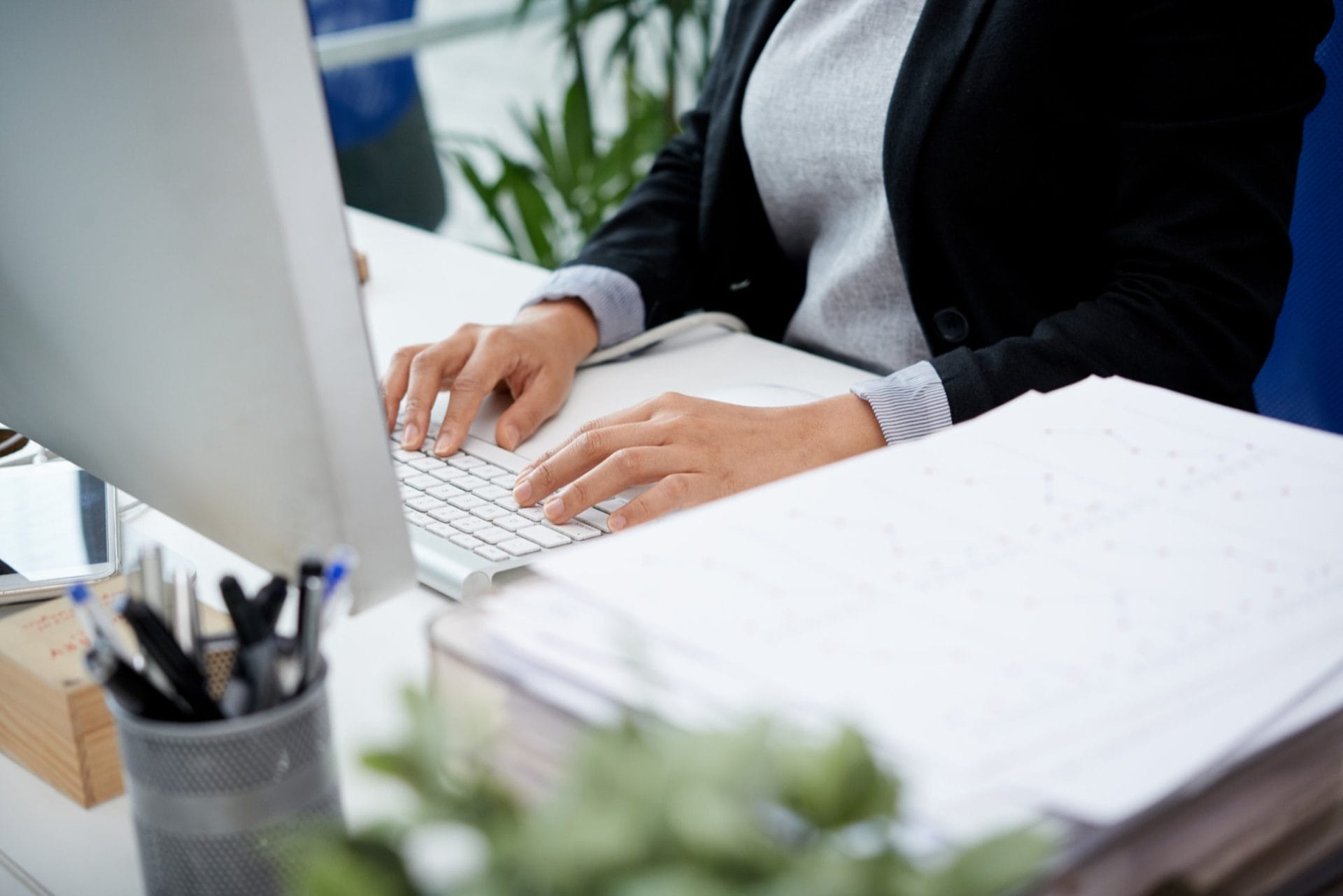 A person typing on a computer keyboard