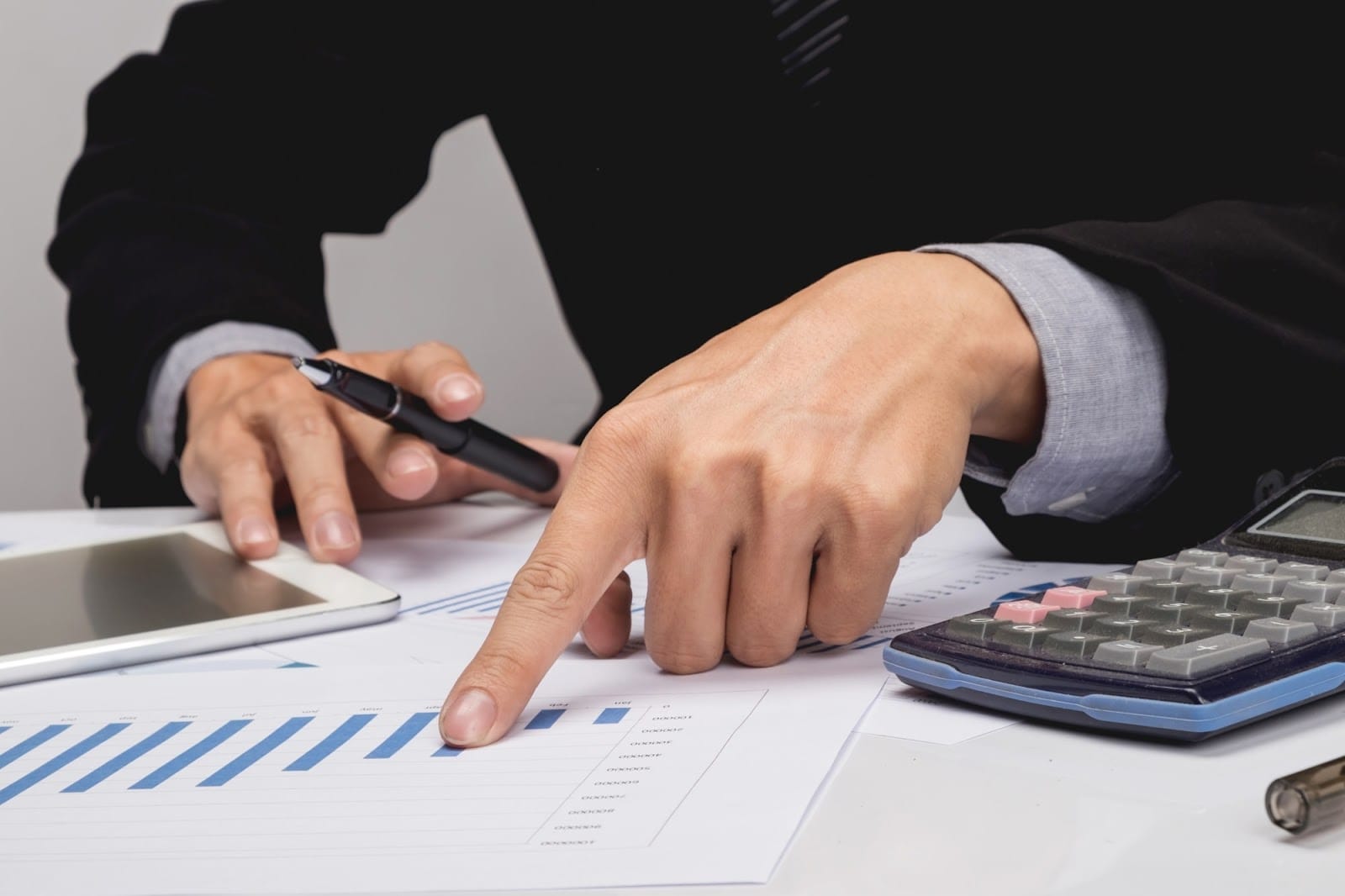 a person holding pointing at the graph