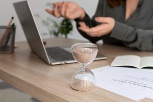 laptop and documents infront of a person