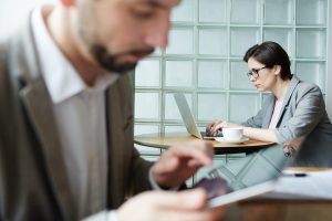two lawyers working on a laptop and a tablet