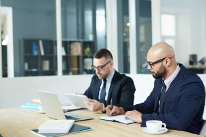 lawyers working with laptops and papers in an office